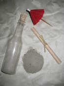 The contents of the bottle - sand, scroll, umbrella