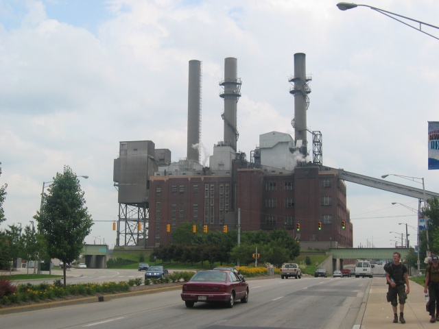 A smoke stack across the street from the park